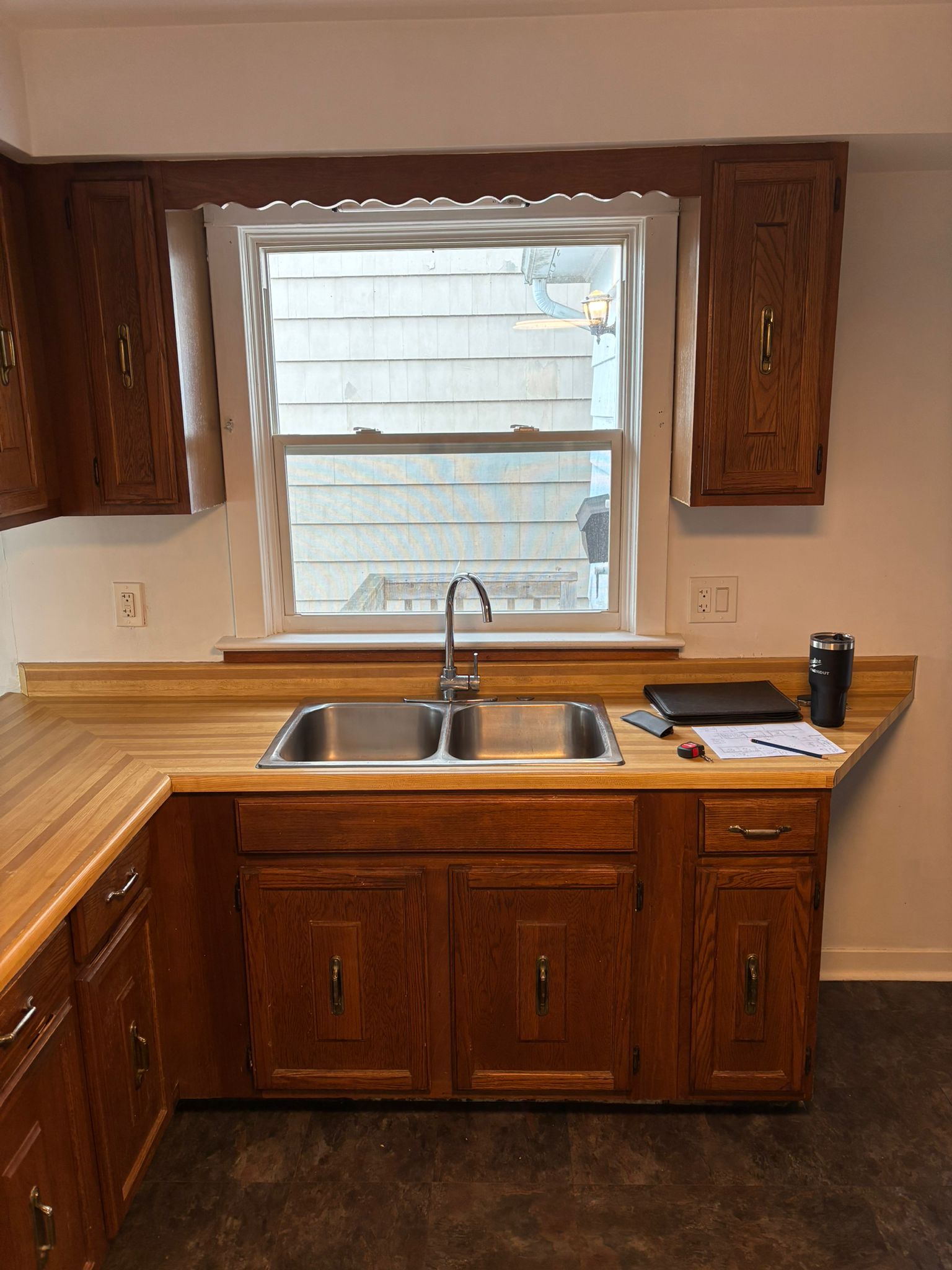 Kitchen cabinets after refinishing — bright white modern finish